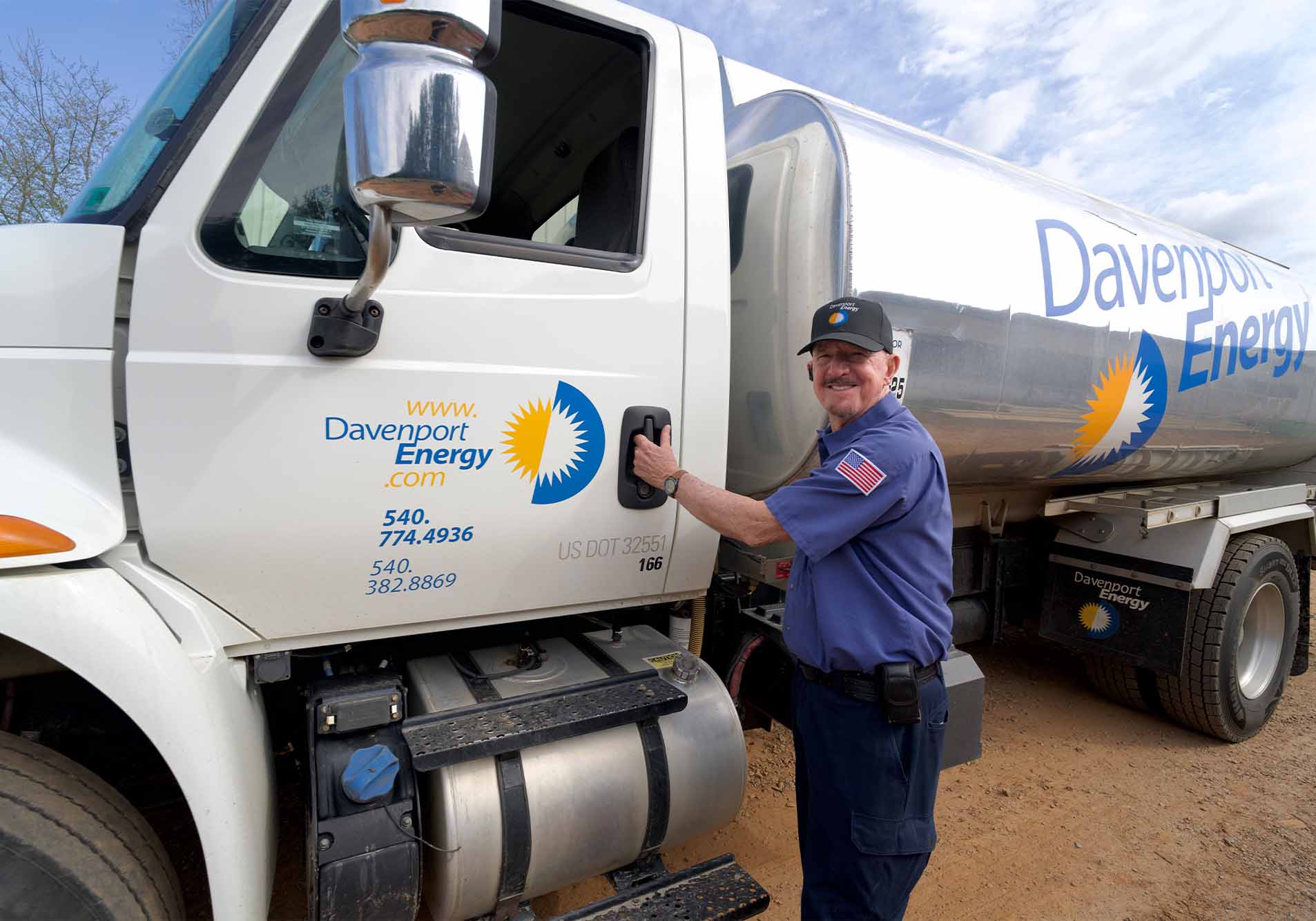 A Davenport Energy driver beside a branded heating oil delivery truck