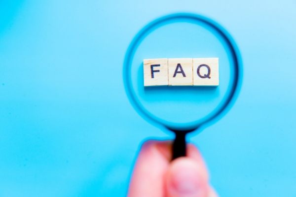 FAQ spelled using wooden letter chips highlighted by a magnifying glass depicting Commercial Propane Efficiency Tips questions