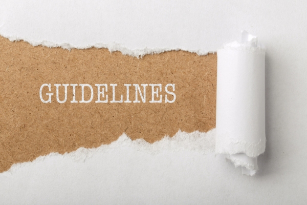 paper tear revealing the word GUIDELINES