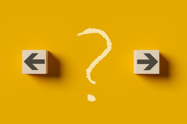 Left and right arrows on wood cubes with question mark in the middle depicting Selecting the Best Propane Delivery Option for Your Household