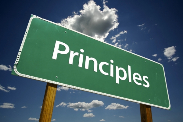 Principles on a green road sign