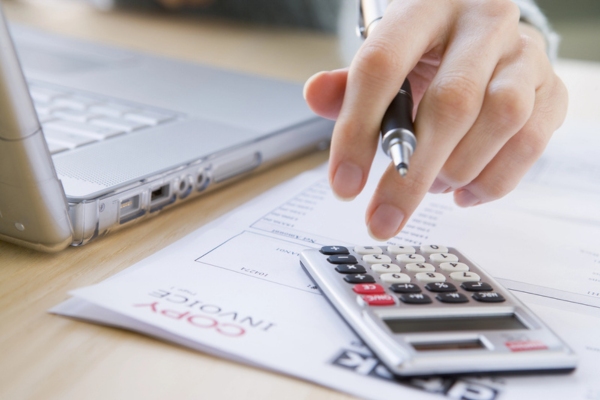 homeowner computing the cost of Automatic Propane Delivery