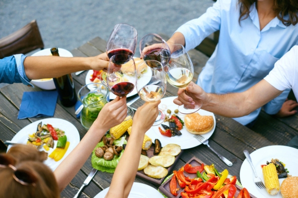 people cheering with drinks at the outdoor dinner party